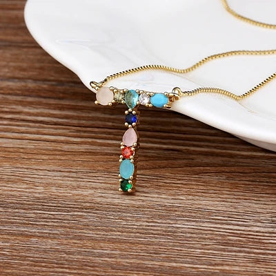 Collar con iniciales y piedras preciosas doradas de 18 quilates