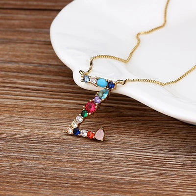Collar con iniciales y piedras preciosas doradas de 18 quilates